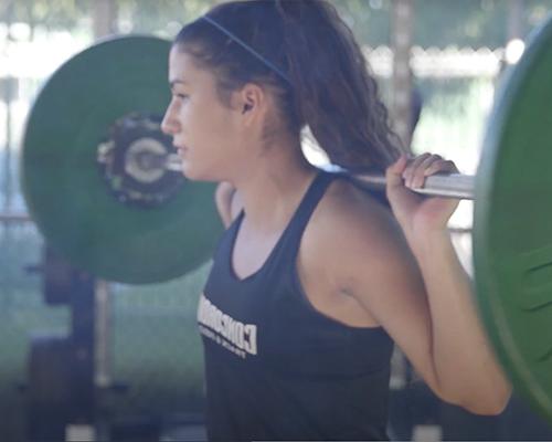 Student athlete lifting weights